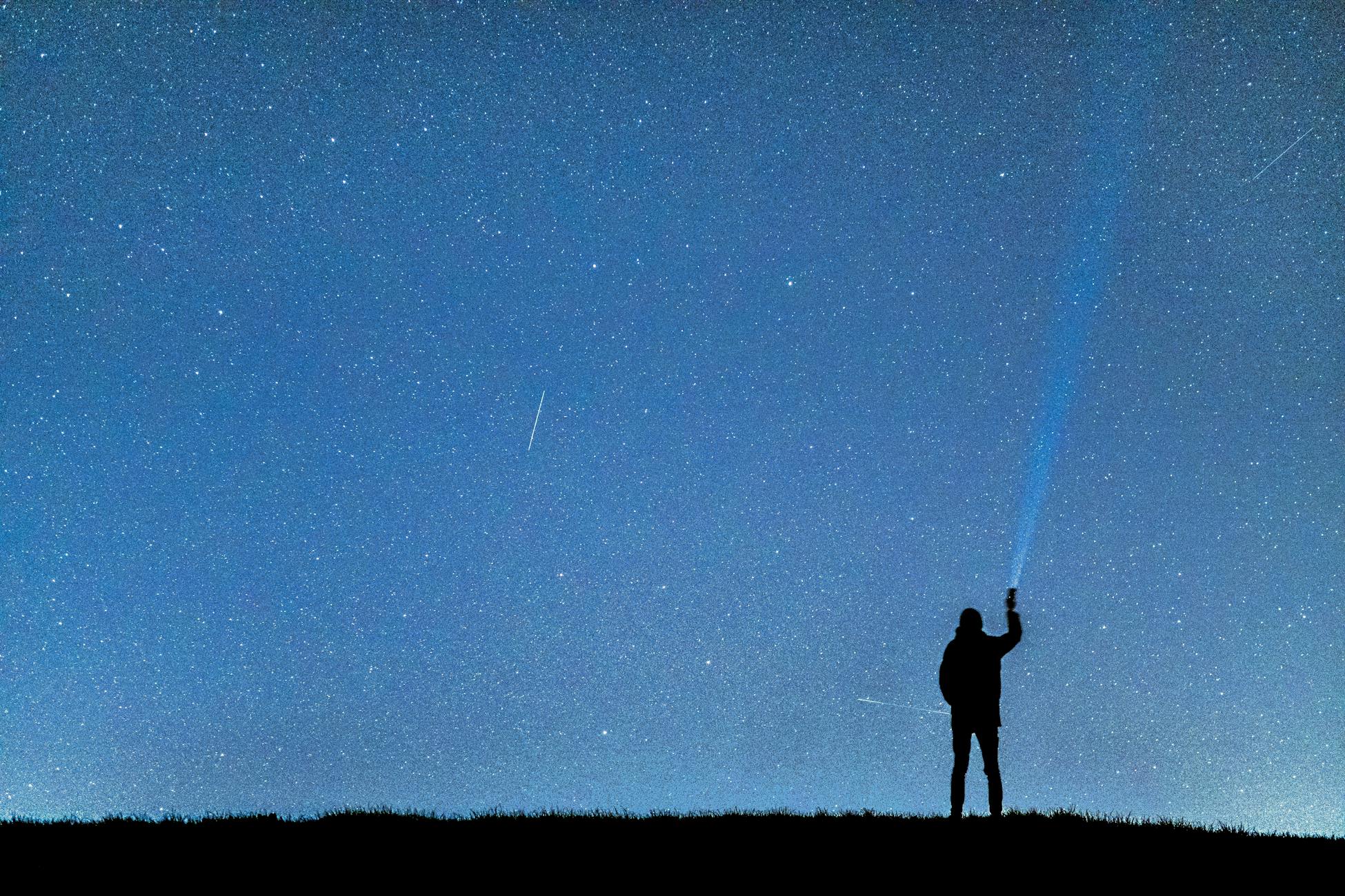 person gazing starry sky