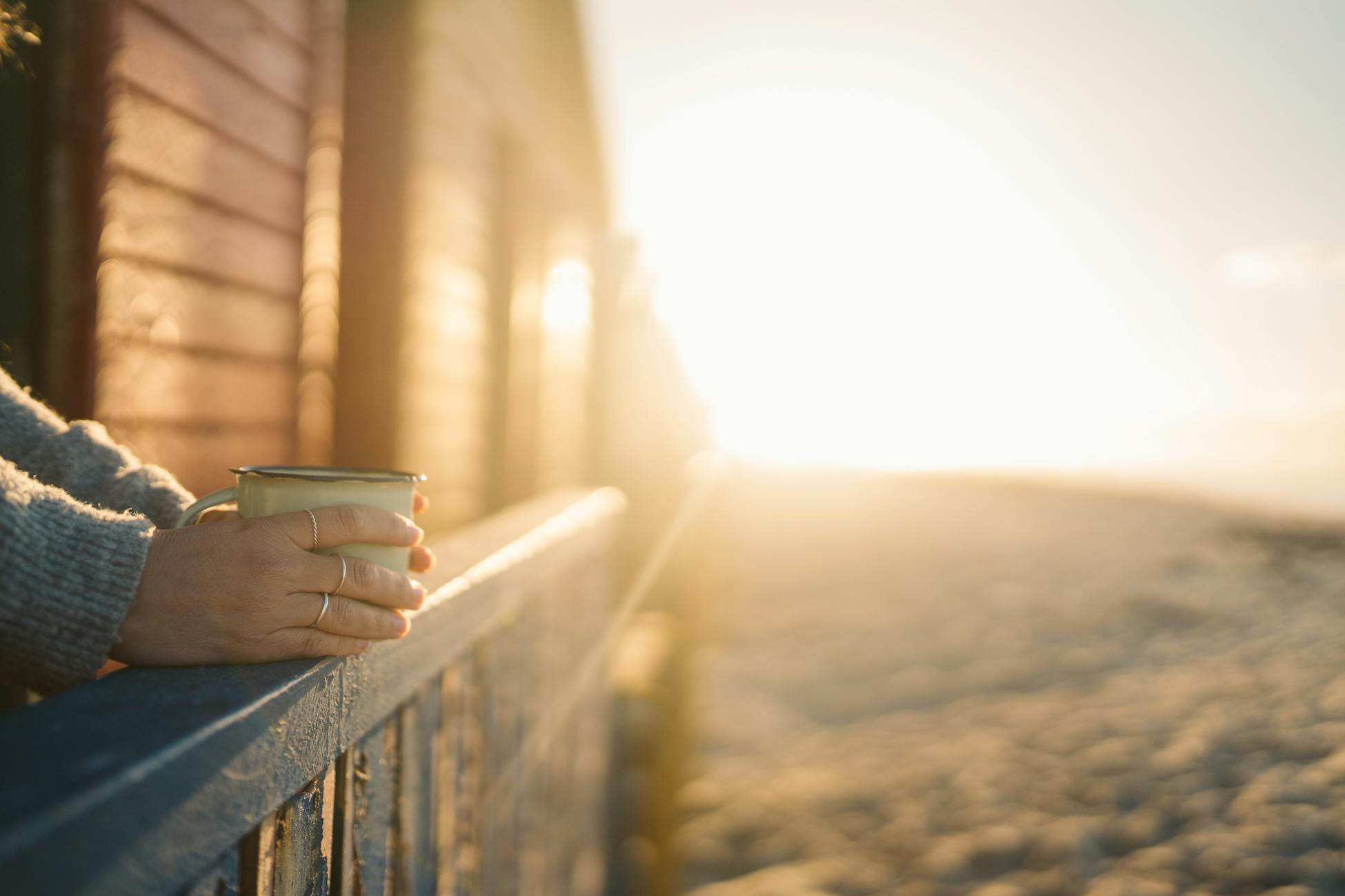 man balcony morning coffee