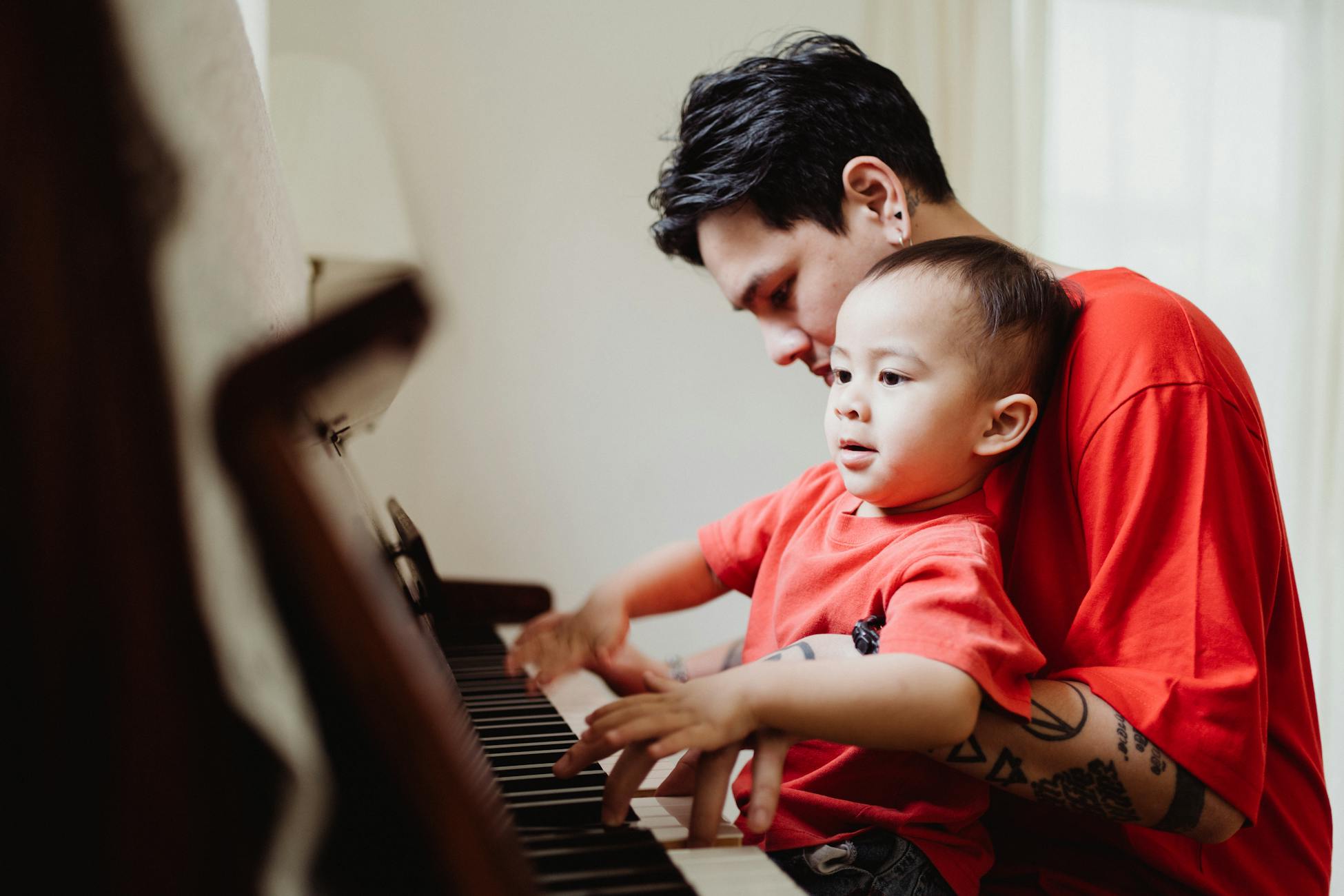father watching child piano
